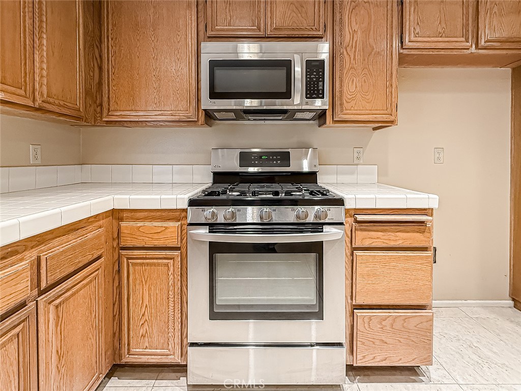 5542 Las Virgenes Road, Unit 97 Calabasas, CA 91302 - Photo 17 of 50 a kitchen with a stove and a microwave
