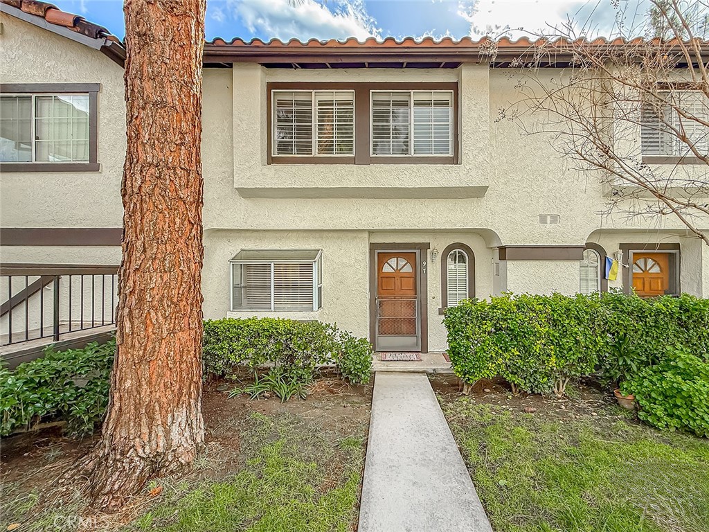 5542 Las Virgenes Road, Unit 97 Calabasas, CA 91302 - Photo 2 of 50 front view of a house with a yard