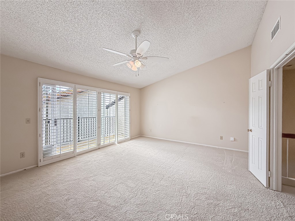 5542 Las Virgenes Road, Unit 97 Calabasas, CA 91302 - Photo 30 of 50 an empty room with chandelier fan and windows