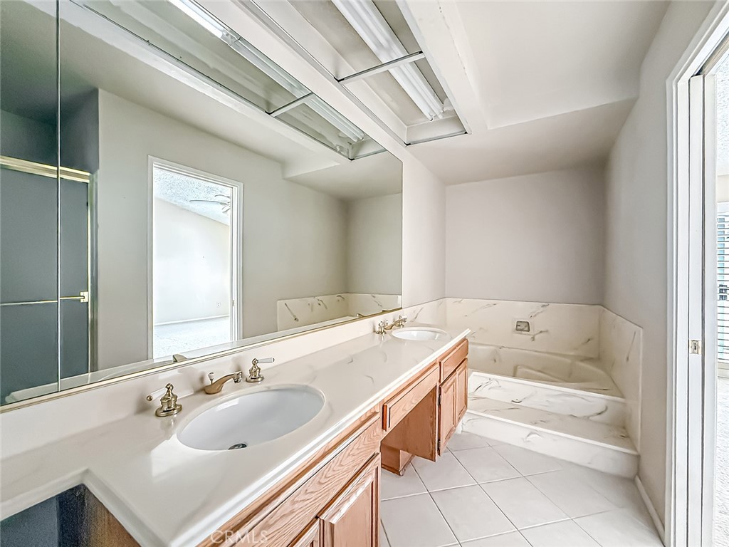 5542 Las Virgenes Road, Unit 97 Calabasas, CA 91302 - Photo 32 of 50 a bathroom with a tub sink and mirror