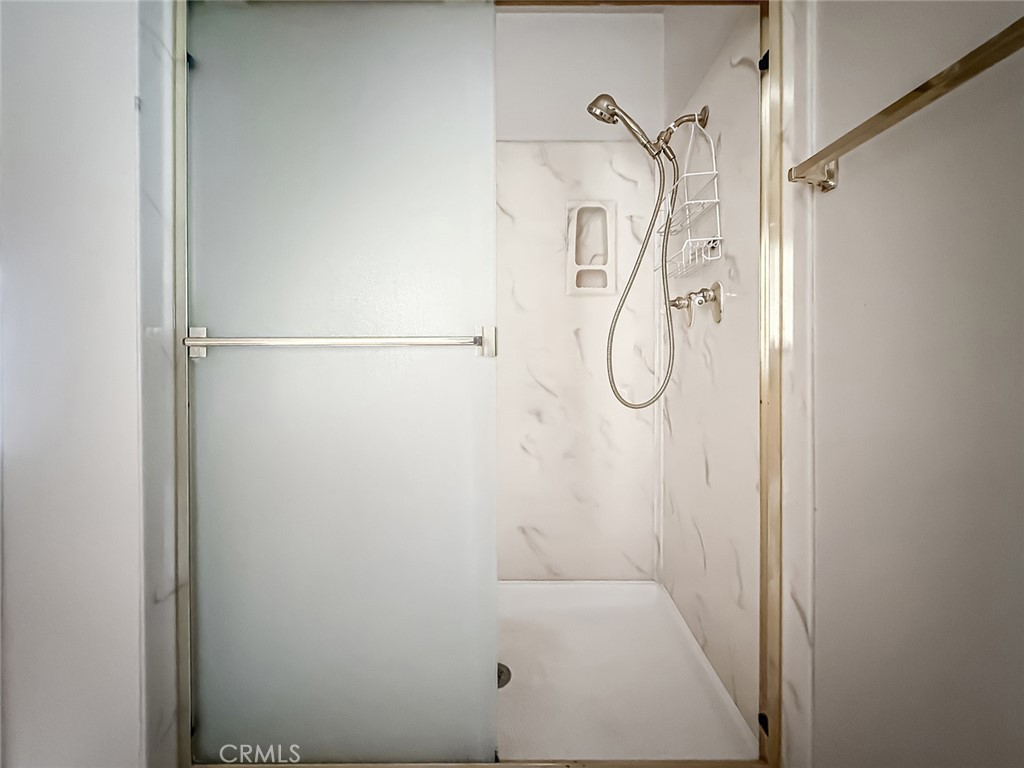 5542 Las Virgenes Road, Unit 97 Calabasas, CA 91302 - Photo 35 of 50 a bathroom with a glass shower door
