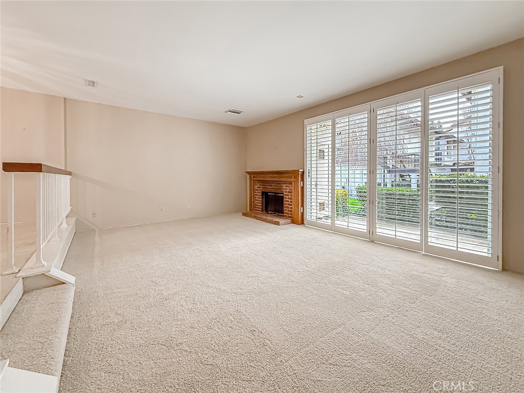 5542 Las Virgenes Road, Unit 97 Calabasas, CA 91302 - Photo 9 of 50 a view of empty room with wooden floor and fireplace