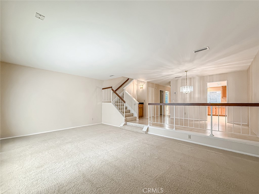 5542 Las Virgenes Road, Unit 97 Calabasas, CA 91302 - Photo 10 of 50 an empty room with stairs and white walls