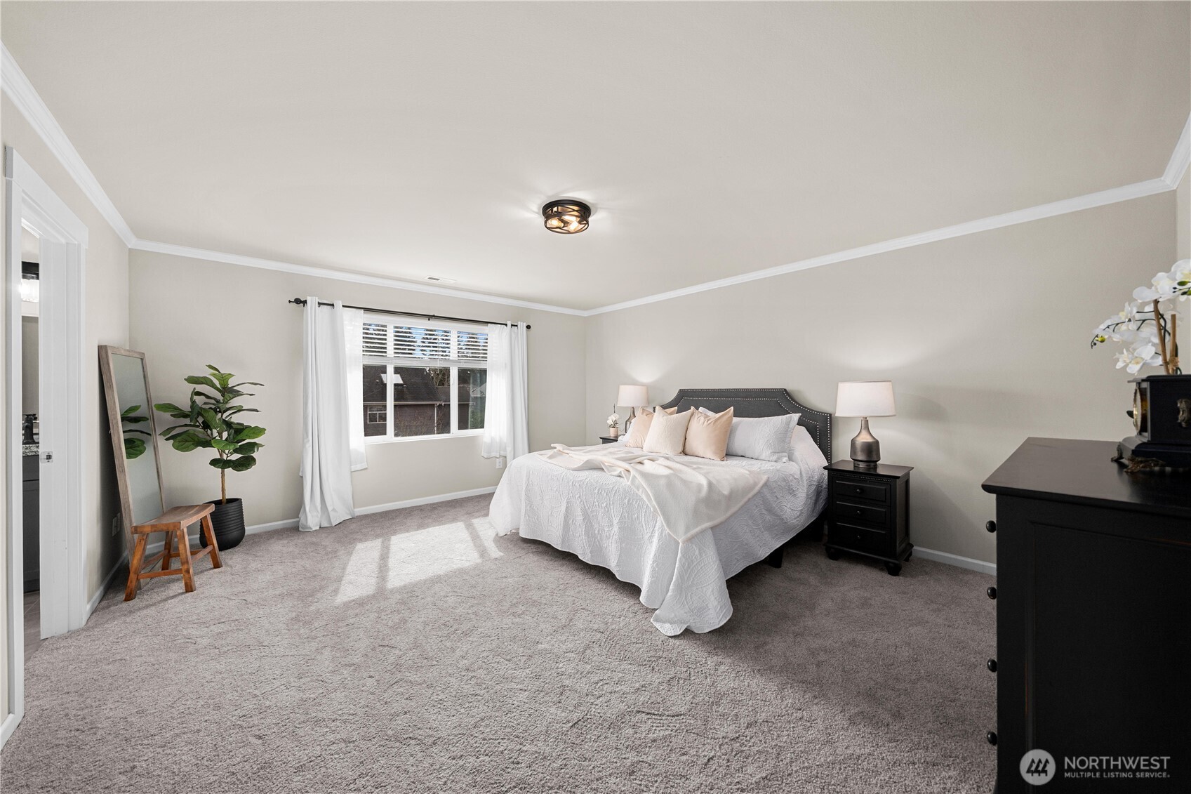 26239 227th Terrace Southeast Maple Valley, WA 98038 - Photo 21 of 37 a bed sitting in a spacious bedroom next to a window and a larger closet