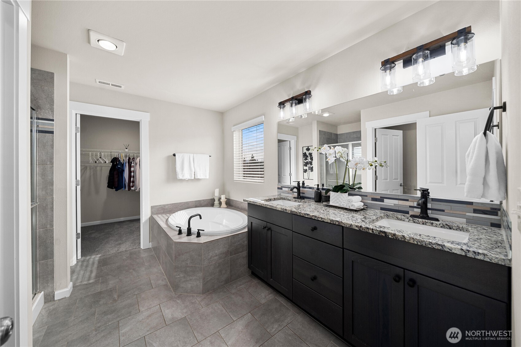 26239 227th Terrace Southeast Maple Valley, WA 98038 - Photo 23 of 37 a spacious bathroom with a granite countertop sink and a mirror