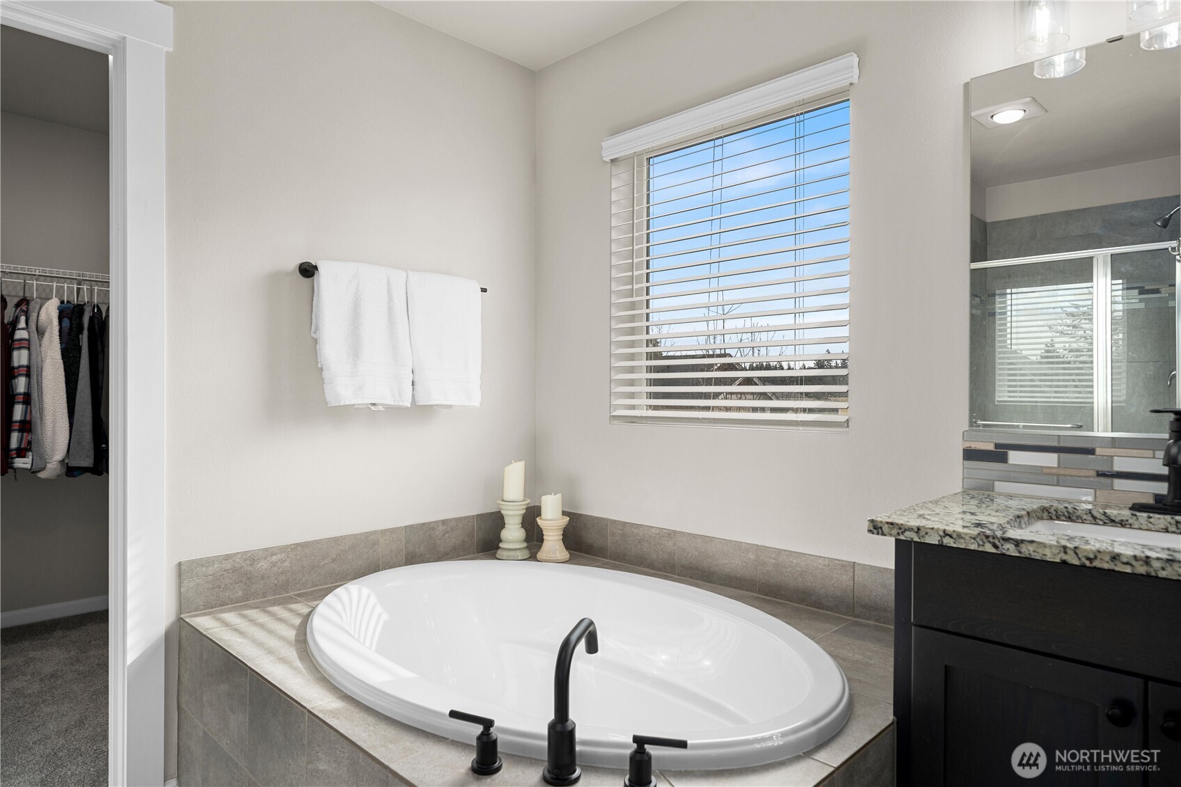 26239 227th Terrace Southeast Maple Valley, WA 98038 - Photo 25 of 37 a bathroom with a granite countertop sink and a bathtub