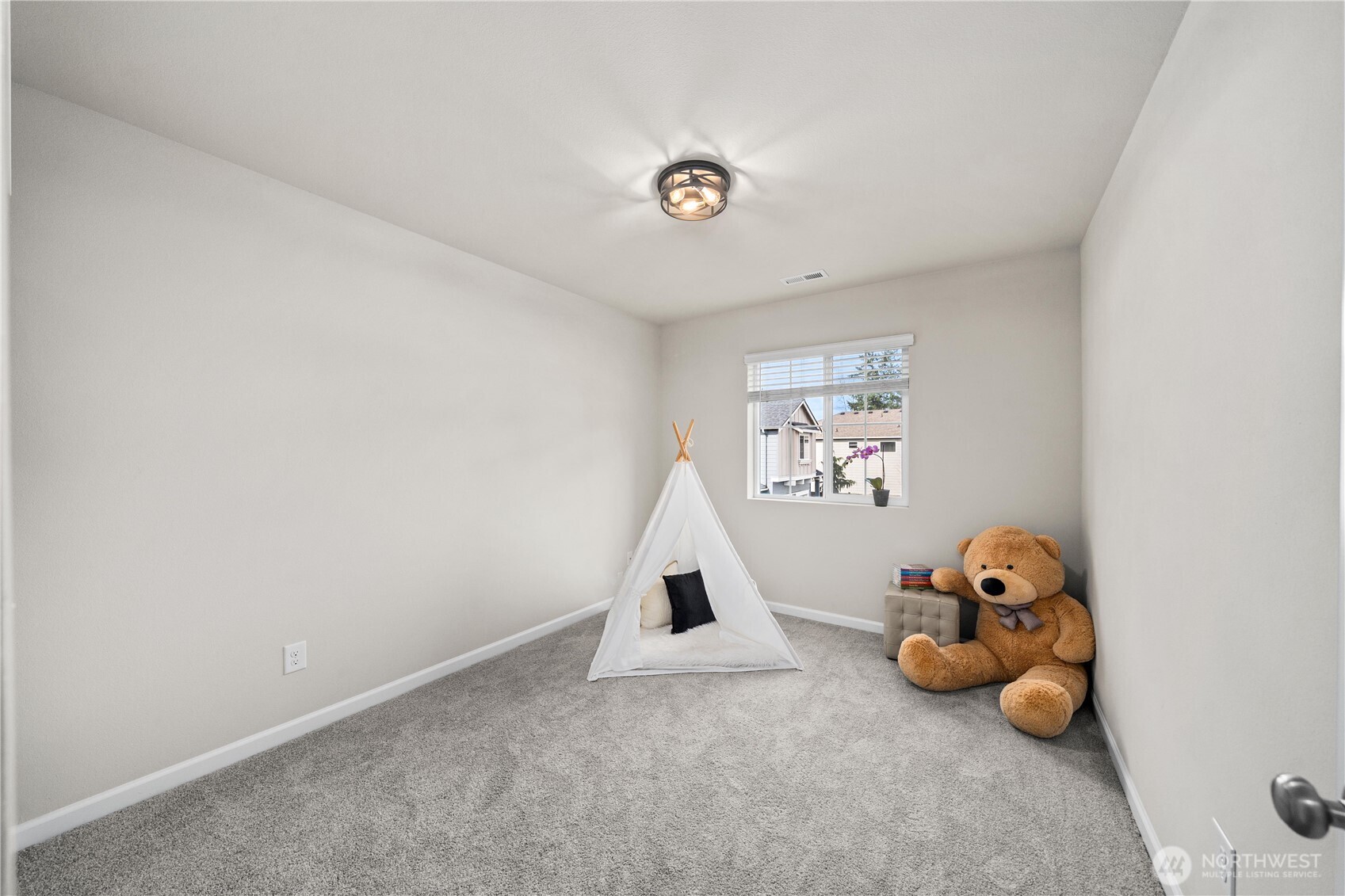 26239 227th Terrace Southeast Maple Valley, WA 98038 - Photo 27 of 37 a bedroom with a bed and a chandelier