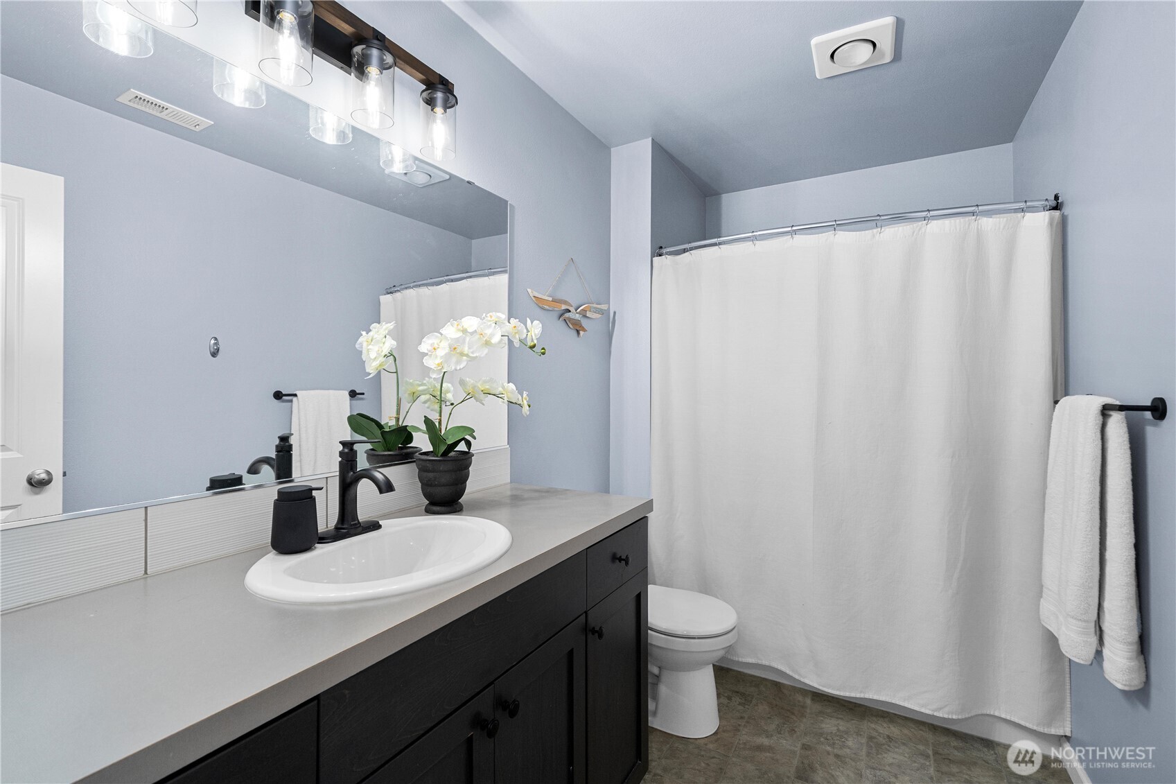 26239 227th Terrace Southeast Maple Valley, WA 98038 - Photo 28 of 37 a bathroom with a granite countertop sink and a mirror