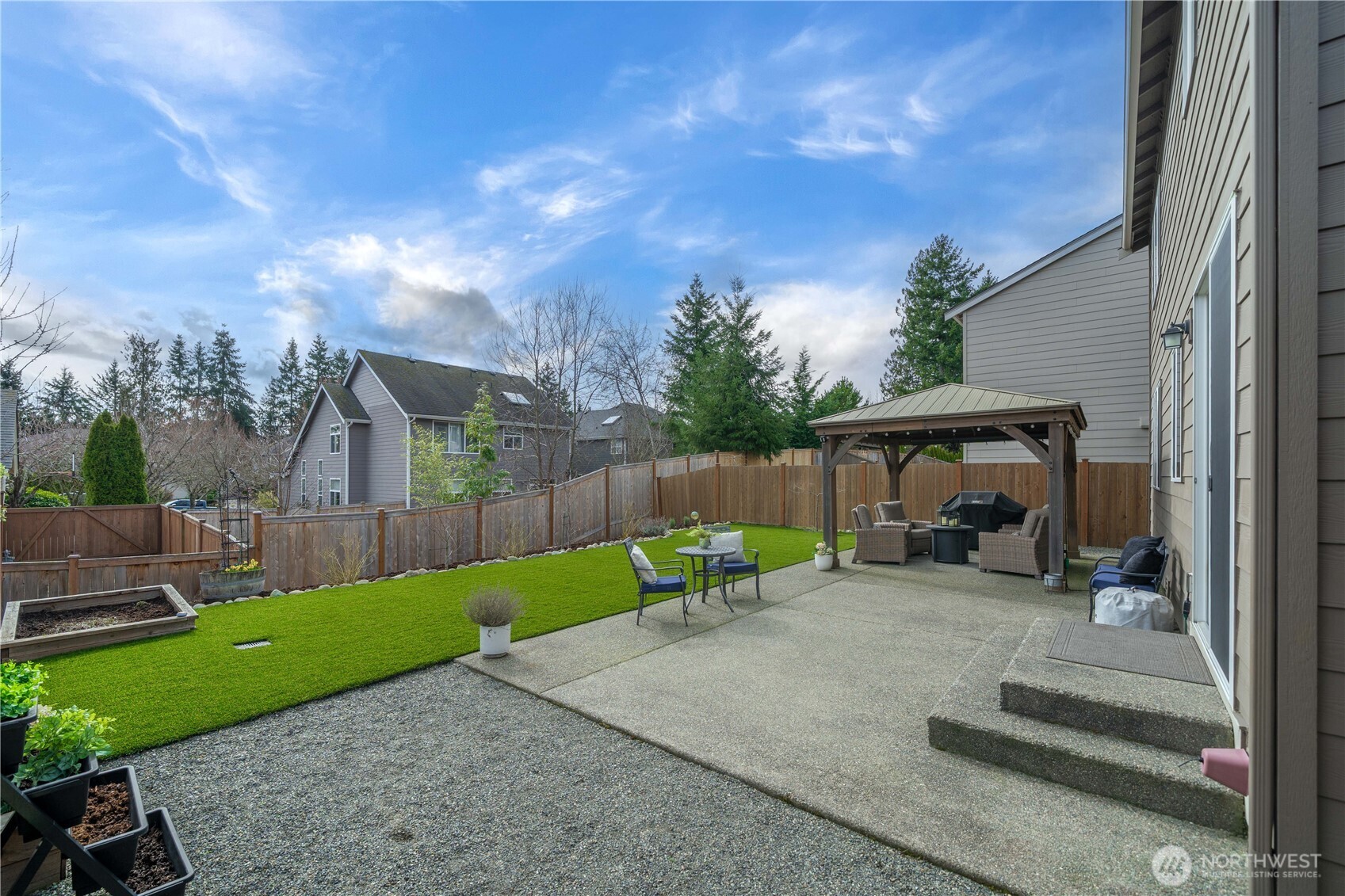 26239 227th Terrace Southeast Maple Valley, WA 98038 - Photo 30 of 37 a view of a chair and tables in patio of the house