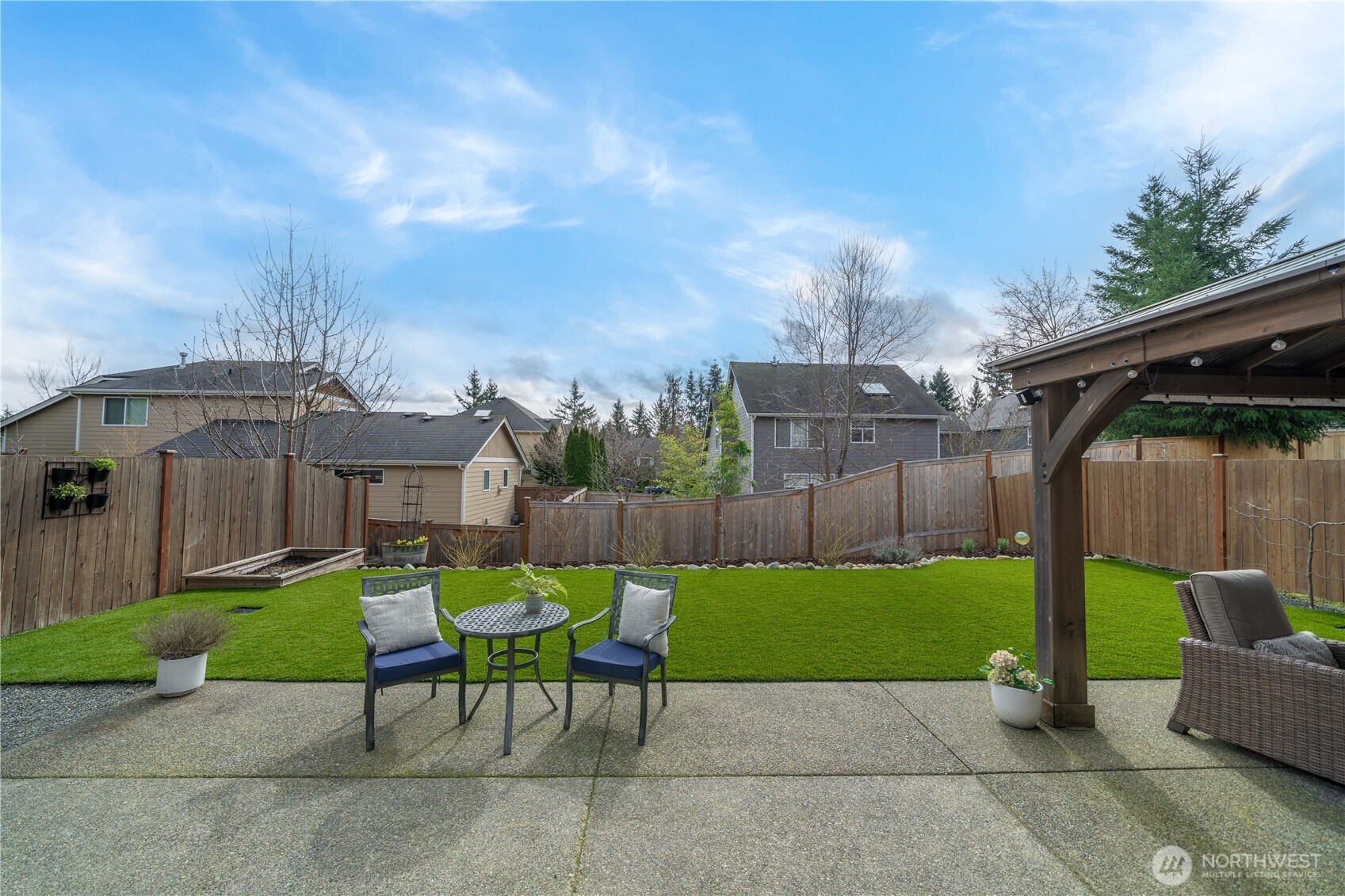 26239 227th Terrace Southeast Maple Valley, WA 98038 - Photo 31 of 37 a view of a chair and table in backyard of the house