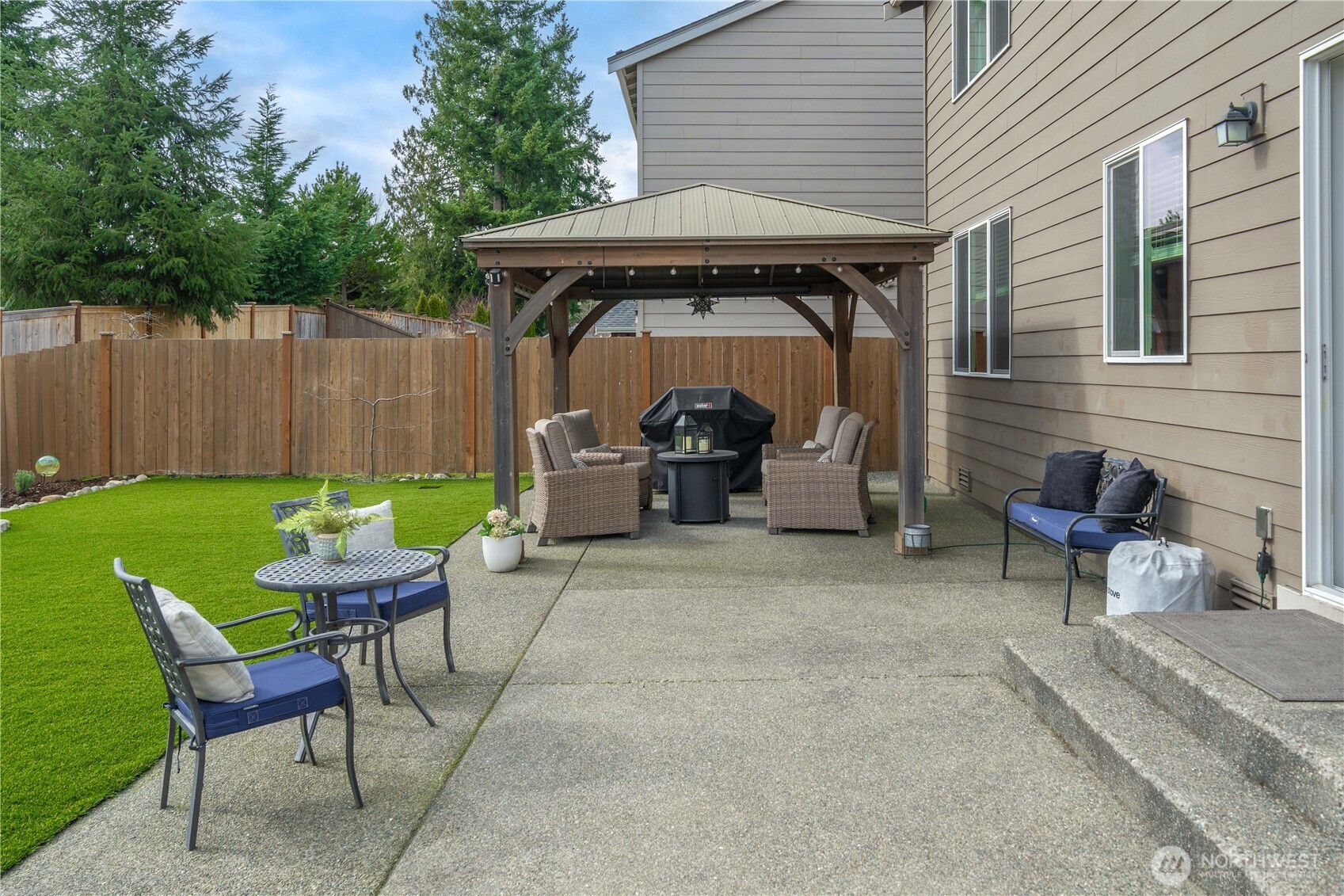 26239 227th Terrace Southeast Maple Valley, WA 98038 - Photo 33 of 37 a view of a patio with table and chairs and potted plants