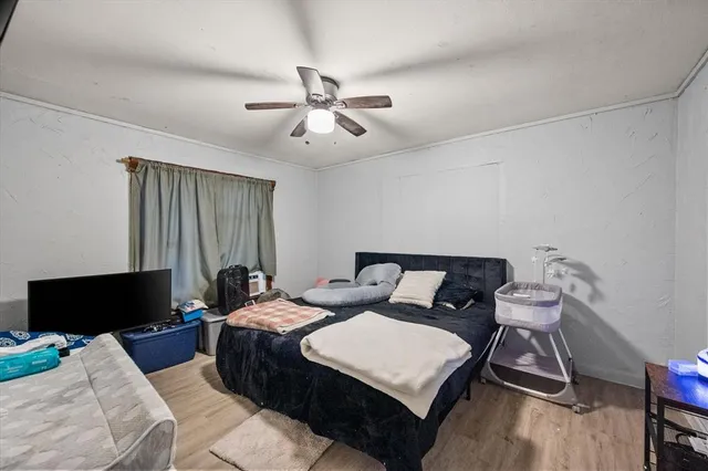 a bedroom with a bed and a television