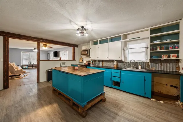 a kitchen with granite countertop a stove and cabinets