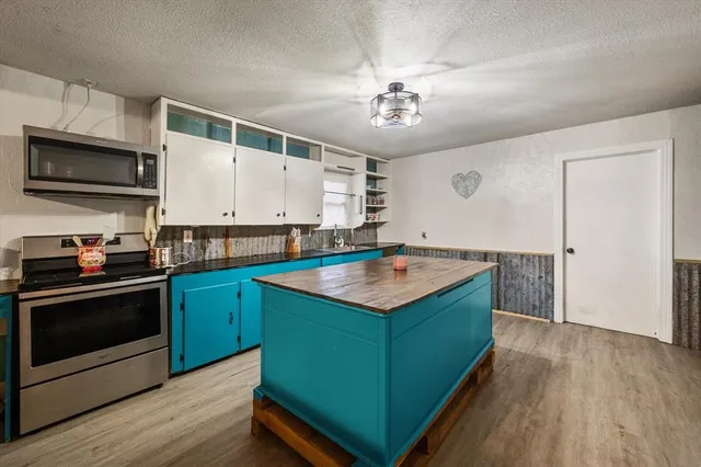 a kitchen with a sink stove and microwave