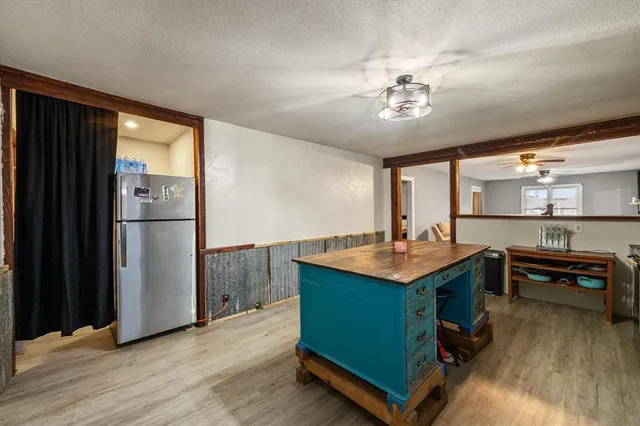 a kitchen with kitchen island a counter top space and stainless steel appliances