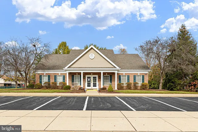 a front view of a building and trees