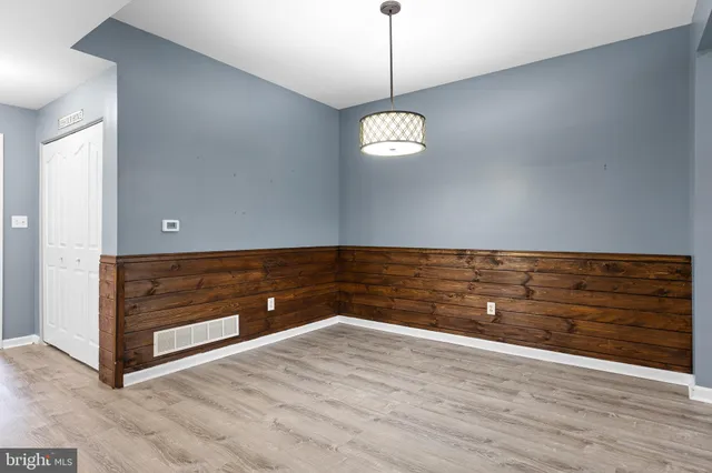 a view of room with window and wooden floor