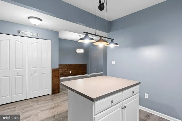 a kitchen with a cabinets and chandelier