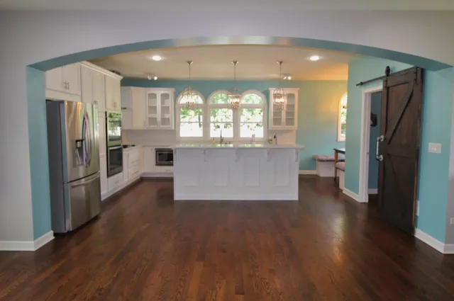 a kitchen with stainless steel appliances granite countertop a white stove top oven and sink