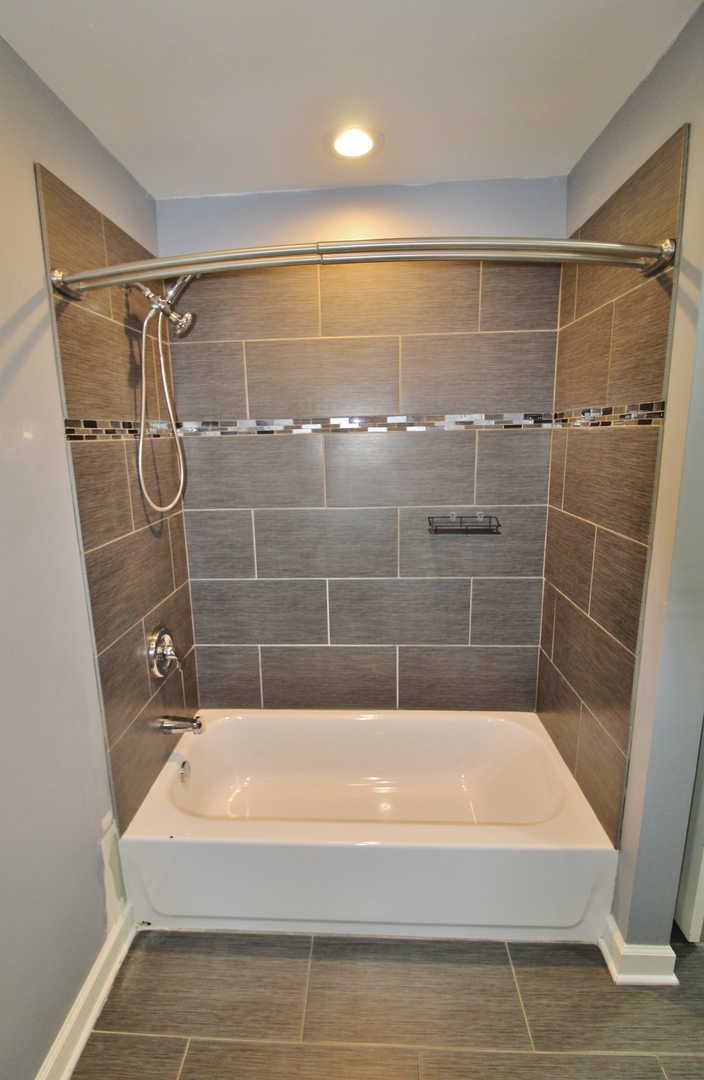 187 West Union Street Seneca, IL 61360 - Photo 37 of 51 a bathroom with a bathtub and a shower