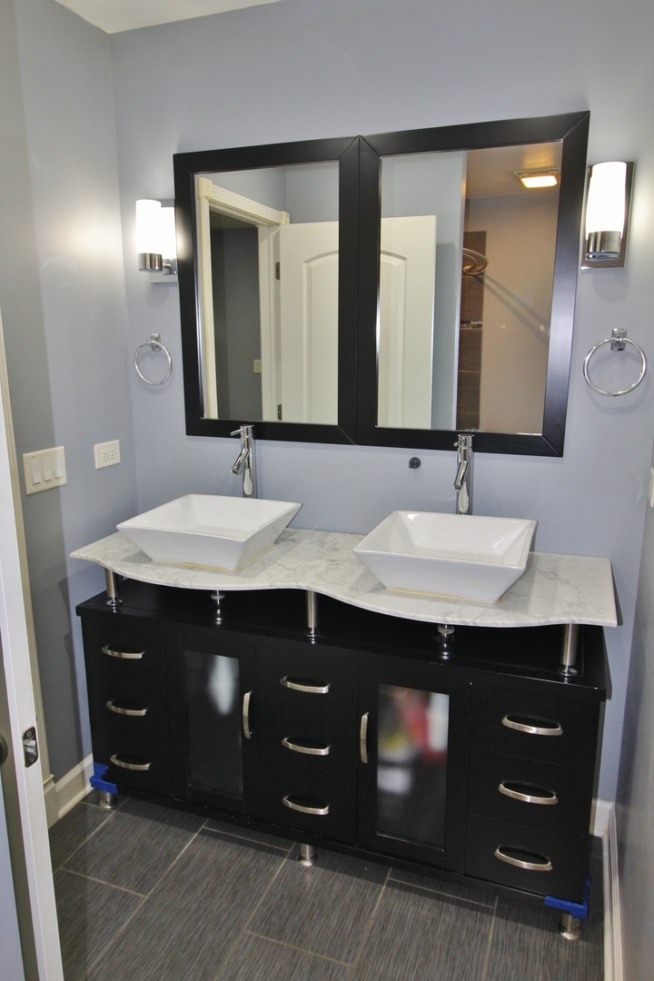 187 West Union Street Seneca, IL 61360 - Photo 38 of 51 a bathroom with a sink double vanity and a mirror