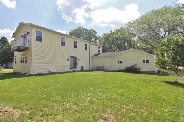 a view of a house with a yard and garage