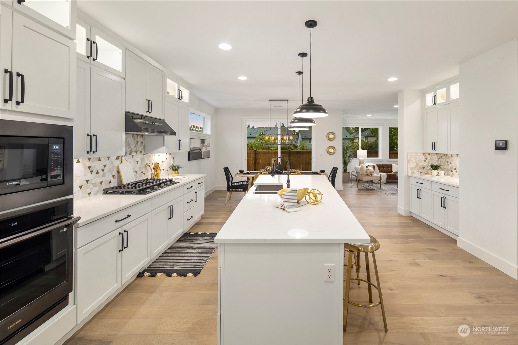 3906 211th Place Southeast Bothell, WA 98021 - Photo 8 of 31 a large kitchen with kitchen island a large counter space a sink appliances and cabinets