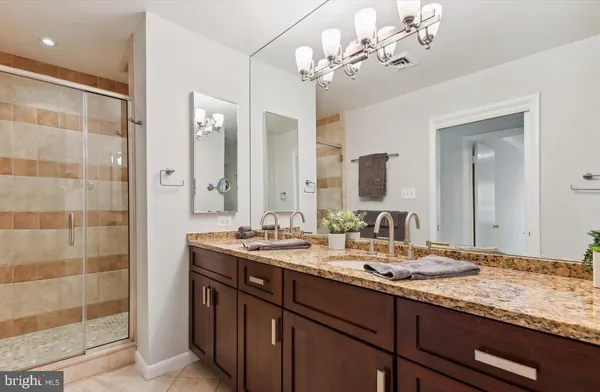 a bathroom with a sink double vanity and a mirror