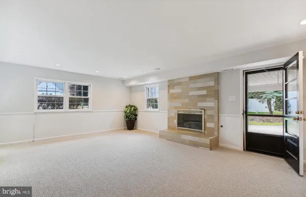 an empty room with furniture and a fireplace