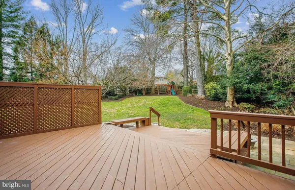 a view of a house with a big yard and sitting area