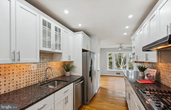 a kitchen with stainless steel appliances granite countertop a stove and a sink
