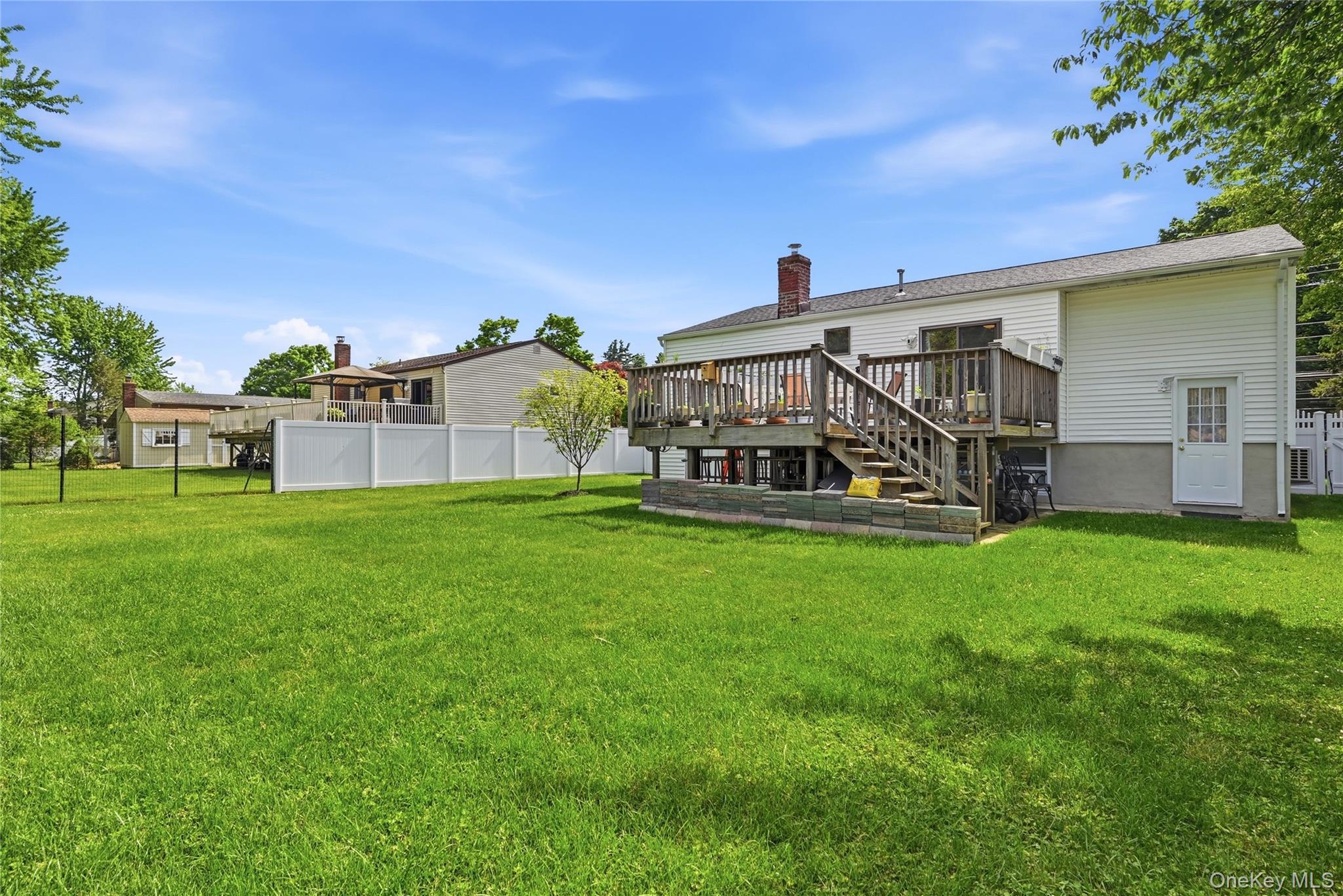 35 Randall Road Shoreham, NY 11786 - Photo 25 of 32 a view of house with a big yard and potted plants