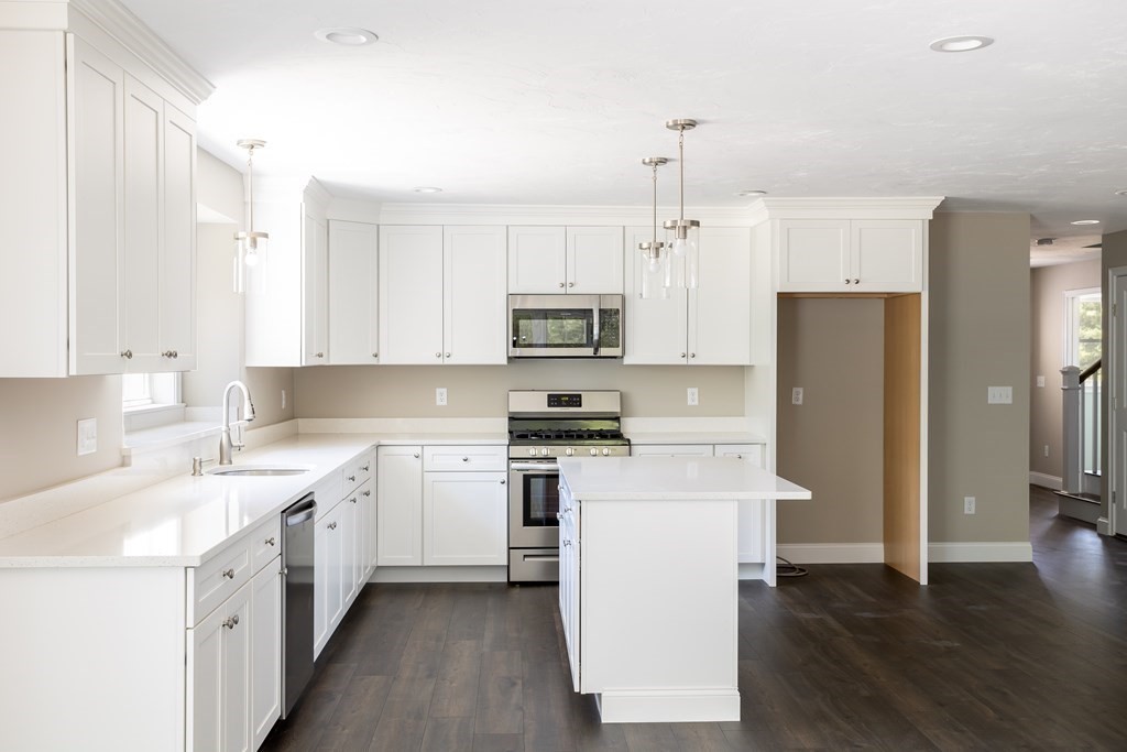 4 Katlyn Circle Rochester, MA 02770 - Photo 4 of 37 a kitchen with a sink a refrigerator a microwave and cabinets