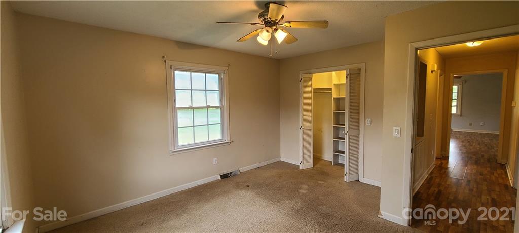 350 Rucker Road Rutherfordton, NC 28139 - Photo 8 of 13 a view of an empty room with window and wooden floor