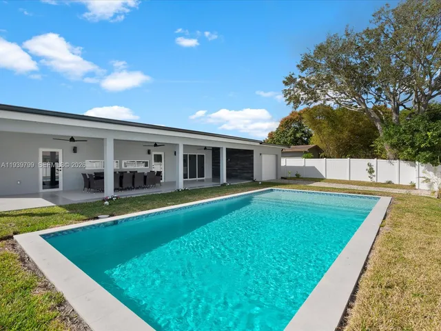 a view of an house with swimming pool and porch