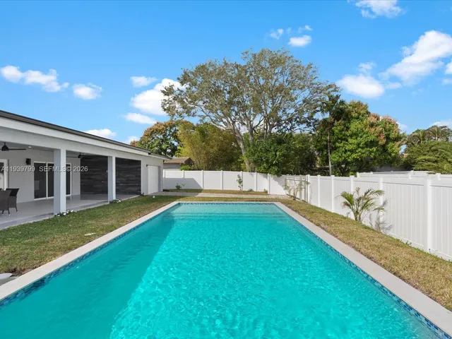 a view of a house with swimming pool and a yard