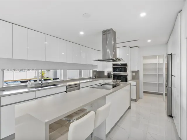 a kitchen with stainless steel appliances a sink stove and refrigerator