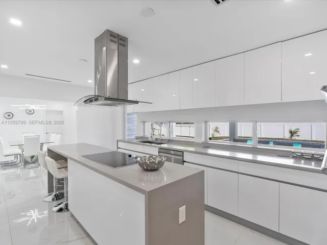 a kitchen with a sink a stove and cabinets