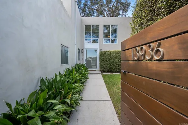 a view of a pathway both side of house