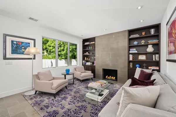 a living room with furniture fireplace and window