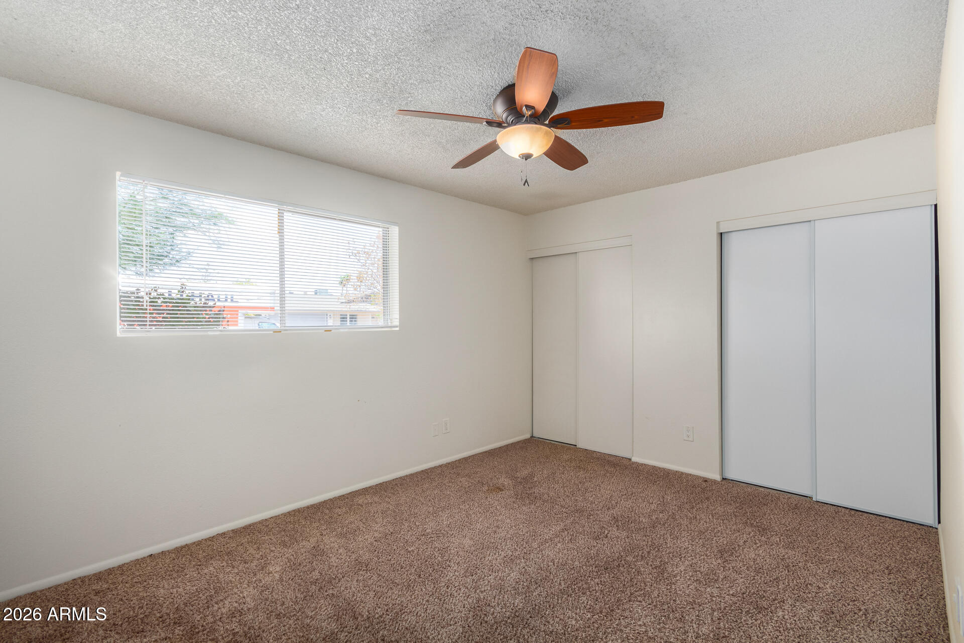 1885 East Alameda Drive Tempe, AZ 85282 - Photo 19 of 34 a view of a big room with wooden floor and windows in a room