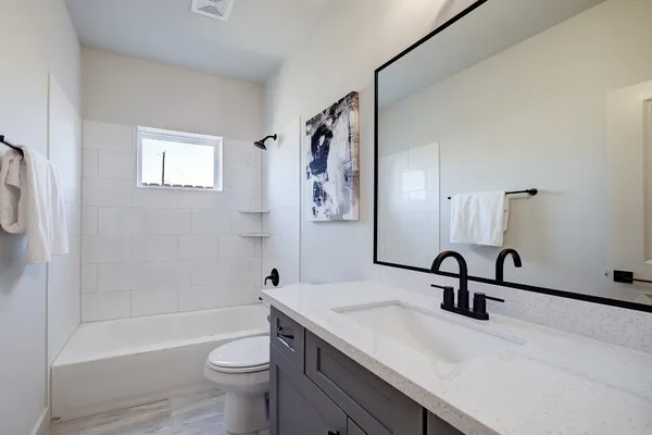 a bathroom with a sink a toilet and a bathtub