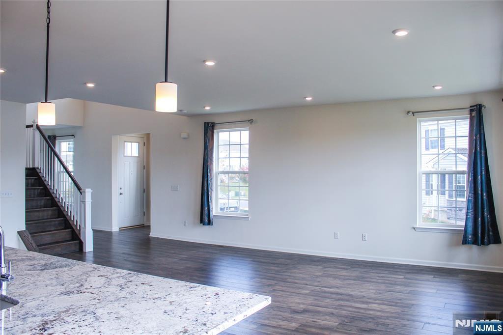 601 Charleston Drive, Unit 601 Monroe Township, NJ 08831 - Photo 11 of 45 a view of an empty room with wooden floor and a window