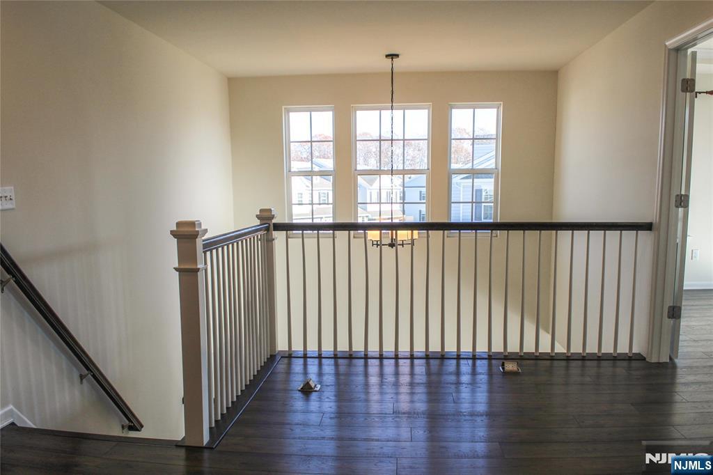 601 Charleston Drive, Unit 601 Monroe Township, NJ 08831 - Photo 17 of 45 a view of empty room with wooden floor and fan