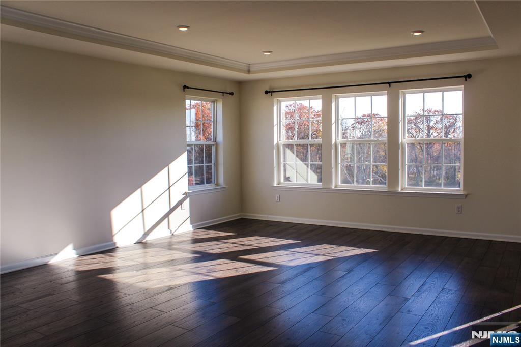 601 Charleston Drive, Unit 601 Monroe Township, NJ 08831 - Photo 19 of 45 a view of an empty room with wooden floor and a window