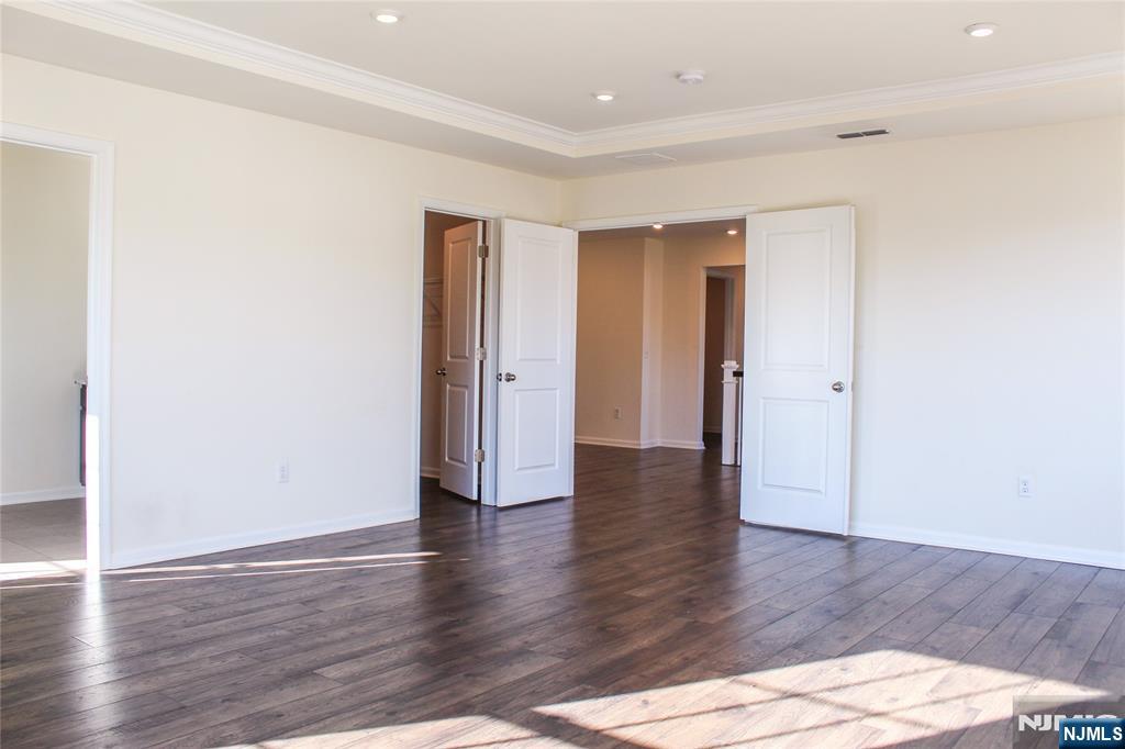 601 Charleston Drive, Unit 601 Monroe Township, NJ 08831 - Photo 21 of 45 a view of an empty room with wooden floor
