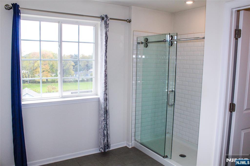 601 Charleston Drive, Unit 601 Monroe Township, NJ 08831 - Photo 24 of 45 a bathroom with a shower and a window