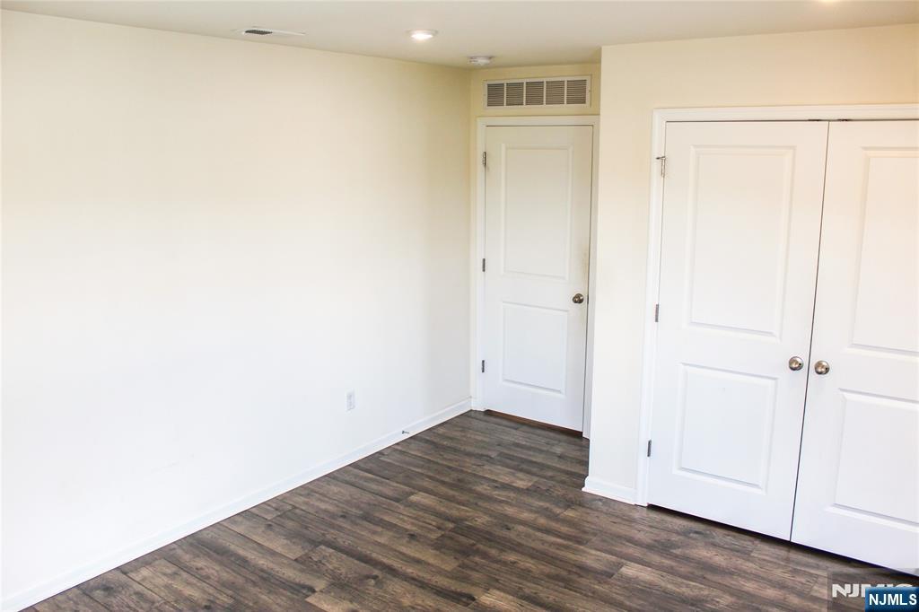 601 Charleston Drive, Unit 601 Monroe Township, NJ 08831 - Photo 27 of 45 a view of an empty room with wooden floor