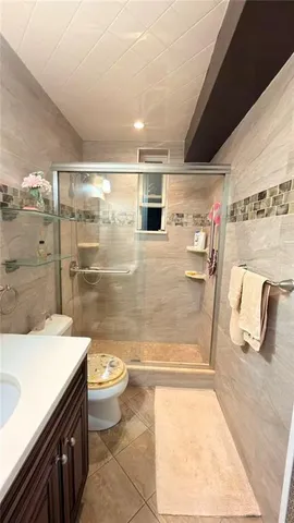 an empty room with closet and windows