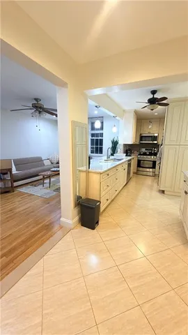 a kitchen with stainless steel appliances granite countertop a stove a sink and a refrigerator